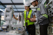 © Nassorn - Group of hispanic people working on robot programming in robotic and electronic engineering laboratory. Latino engineer team learning and research automated machine with intelligent mechanical control
