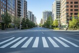 Empty city street with crosswalk, green trees, modern buildings and blue sky day