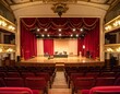 © Tuachan - Elegant Theater Stage with Red Drapes and Wooden Floor