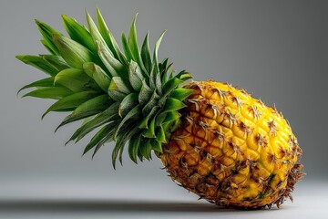 Poster - Fresh pineapple displaying vibrant yellow skin and lush green leaves on a neutral background