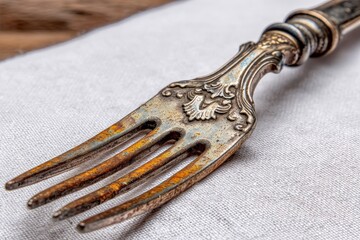 Aufkleber - Rustic antique fork on linen fabric showcasing intricate details and worn finish in a warm, inviting setting