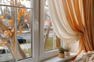 Poster - Cozy window view of autumn foliage and urban landscape with soft drapes in natural light