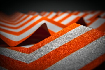 Poster - Bright orange fabric with sharp zigzag patterns creates a striking visual texture in a modern design setting