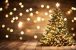 © lantecreative - Christmas tree on wooden floor, bokeh background.  Illuminated tree with ornaments, warm lighting on rustic wood