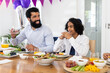 © Wavebreak Media - Diverse family, Father and son enjoying festive meal together, smiling and celebrating at home
