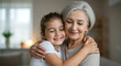 © Tgad - Grandmother and granddaughter hugging together family love care happiness relationship senior woman child smile