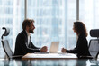 © Mitu321 - Focused conversation between corporate professionals at meeting