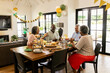 © WavebreakMediaMicro - Celebrating birthday, African American family sharing cake and laughter at home