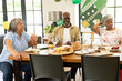 © WavebreakMediaMicro - Celebrating retirement, African American seniors sharing food and laughter at home