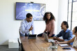 © wavebreak3 - Diverse team discussing project strategy with laptops in modern office meeting