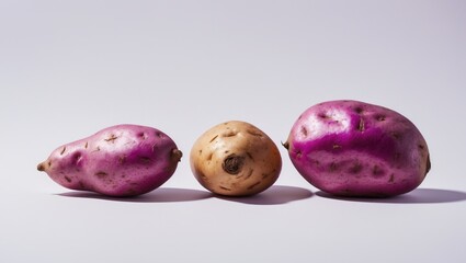 Aufkleber - Whole and raw sweet potatoes and yams displayed on a white background featuring purple tones