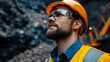 © Jorda - Miner in Safety Gear Looking Upwards