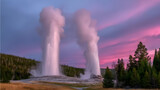 geyser eruptions shooting boiling water into a colorful sunset