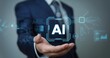 © MDOFF656 - Businessman holding a virtual hologram of an AI icon with the text 'AI' on his hand, a digital technology concept for business and industry where a man in a suit is using artificial intelligence