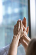 © zinkevych - Close up of hands clasped together in the air