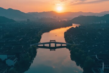Poster - Beautiful sunset over bridge and lake with surrounding buildings captured from above, Aerial shot of bridge, lake, and surrounding buildings in a Chinese town at sunset