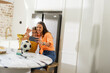 © wavebreak3 - Mother and daughter taking selfie with soccer trophy in kitchen, smiling happily