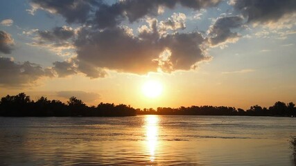 Poster - Witness captivating transformation as sun gracefully sinks below horizon over Sava River. Time lapse sunset. Vivid colors dance across sky, silhouettes of trees. Stunning backdrop. Serbia at spring