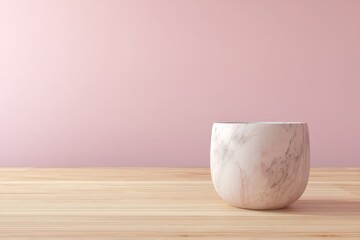 Poster - Empty marble bowl on a light wooden surface against a pastel pink backdrop.