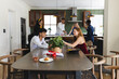 © wavebreak3 - Teenagers celebrating at home, enjoying food and conversation around dining table