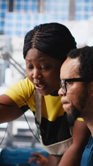 Poster - vertical video black engineers collaborate on photovoltaic system designs at computer, focused on ec