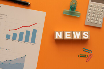 Poster - there is wood cube with the word news. it is as an eye-catching image.