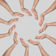 © New Africa - Making circle of human hands on grey background. Unity, partnership, cooperation
