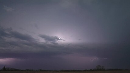 Wall Mural - overcast sky with lightning strike over fields. static shot
