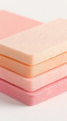 Poster - Stack of Pastel Pink and Orange Foam Blocks on White Background