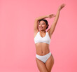 © New Africa - Woman in underwear with smooth skin after epilation procedure on pink background, space for text