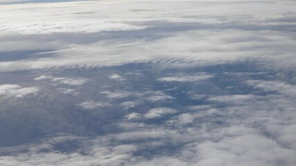 Wall Mural - blue sky with white fluffy clouds from airplane flight fly over the clouds in a sunny day with cloud moving in summer time