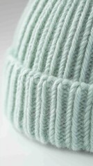 Poster - Close-up of a Knitted Beanie Hat in Light Green Color; Macro Shot Showing Texture and Detail of the Wool Fabric; Winter Fashion Accessory