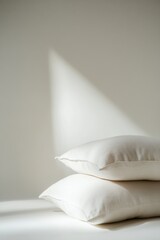 Poster - Two Pillows Stacked in Minimalist Style with Natural Light and Shadow on White Background in Studio