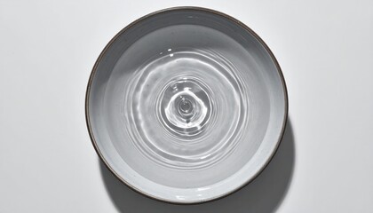 Poster - Rippling water action in a shallow bowl minimalist interior setting aerial view tranquil concept