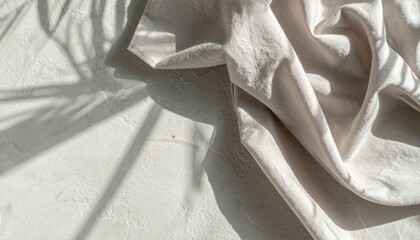 Poster - Textured fabric draped on light surface with shadow play studio photography minimalist aesthetic