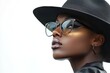 © HO - fashion editorial style image of black woman with hat and glasses, white background