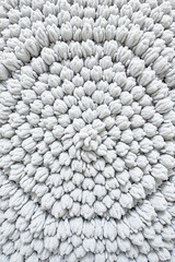 Leinwandbilder - Close up of a circular pattern made of small, soft, white tufts arranged in concentric circles, creating a textured and dimensional surface.