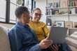 © ReeldealHD images - Happy mature woman looking at finances on their laptop with her partner