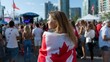 © Kenny - Young caucasian female celebrating canada day at outdoor festival with crowd and canadian flag