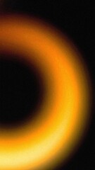 Wall Mural - abstract blurry gradient orange yellow ring shape with heavy grain texture on black background