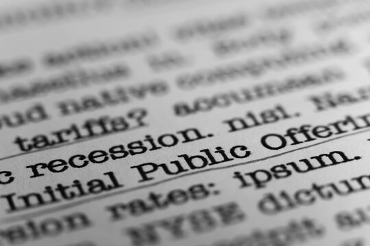 Initial Public Offering. Text printed on a page. A piece of paper with a phrase written in retro typewriter font. IPO