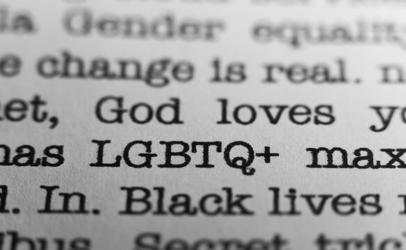 LGBTQ plus. Text printed on a page. A piece of paper with a phrase written in retro typewriter font