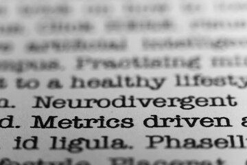 Poster - Metrics driven. Text printed on a page. A piece of paper with a phrase written in retro typewriter font