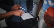 © EinFrame25/peopleimages.com - Tablet screen, coaching and football with hands in locker room for game plan, sports strategy or defense formation. Touchdown tactics, match feedback and discussion with people and training advice
