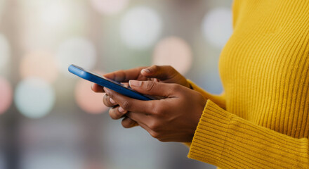 Woman's hands holding and interacting with a blue mobile phone