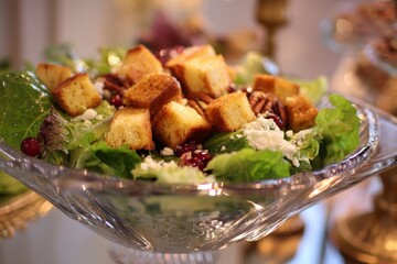 Aufkleber - Fresh salad with croutons and nuts served at a festive gathering in a beautifully decorated setting