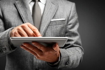 Poster - Business professional engaging with a tablet in a formal setting during a conference