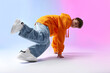 © New Africa - Boy in stylish clothes dancing on color background