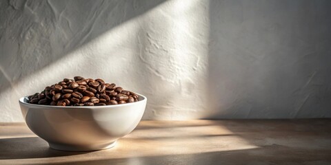Poster - A bowl of roasted coffee beans sits on a table in sunlight, a simple still life composition.