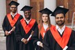 © anatoliycherkas - Diverse Group of Happy Graduates in Caps and Gowns Celebrating Success in Front of University Building
